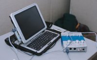 Alex's portable digital recording equipment, including laptop, external sound interface, and professional-quality microphones
